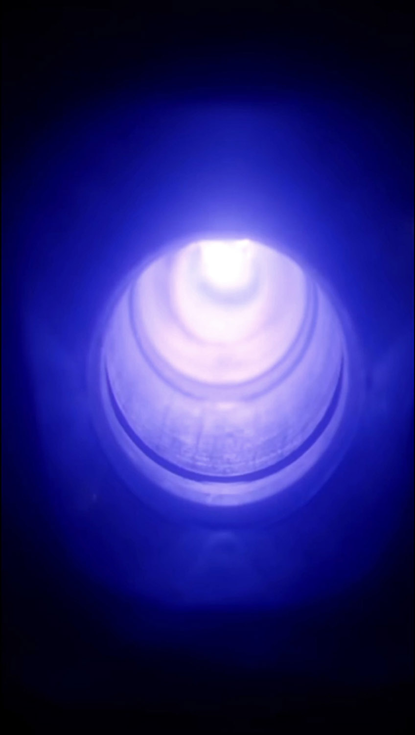 Pipe being restored via blue light curing